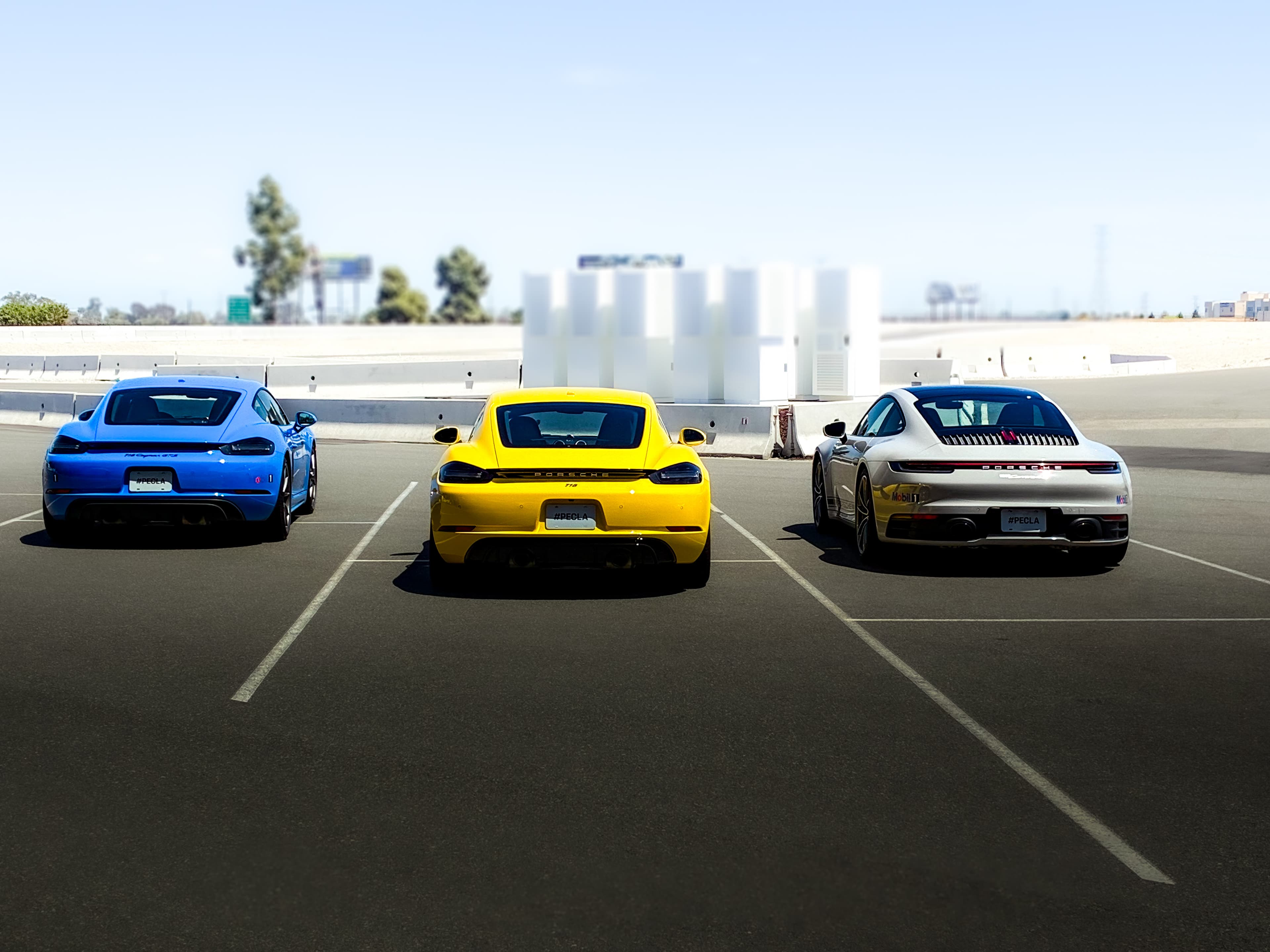 Three Porsches lined up at the track